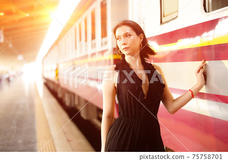 LGBT Transgender model travels on train at station railway LGBT Transgender model travels on train at station railway 75758701