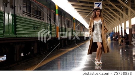 Young model travels on train at station railway in Summer Young model travels on train at station railway in Summer 75758888