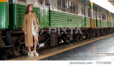 Young model travels on train at station railway in Summer Young model travels on train at station railway in Summer 75758890