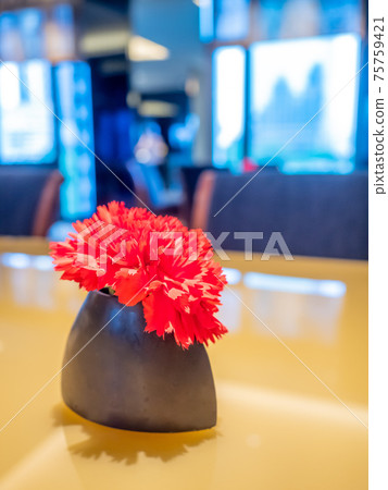 Red flower on table Red flower on table 75759421