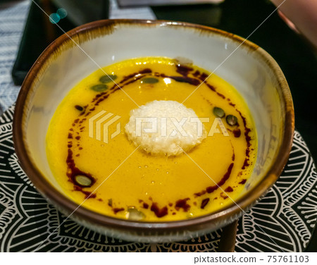 Pumpkin soup with seeds in Mediterranean style restaurant Pumpkin soup with seeds in Mediterranean style restaurant 75761103