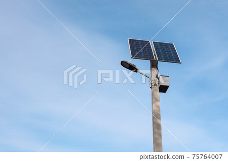 solar panel on a lamppost against the blue sky  75764007