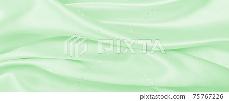 Smooth elegant green silk or satin luxury cloth texture as abstract background. Luxurious background design 75767226