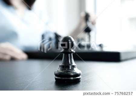 The hands of businesswomen moving chess in chess competitions demonstrate leadership, followers, and strategic plans, business success building processes, and teamwork 75768257