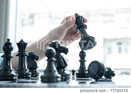 The hands of businesswomen moving chess in chess competitions demonstrate leadership, followers, and strategic plans, business success building processes, and teamwork The hands of businesswomen moving chess in chess competitions demonstrate leadership, followers, and strategic plans, business success building processes, and teamwork 75768258