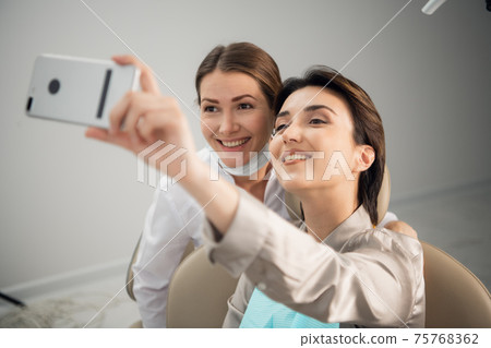 A selfie with a doctor after a dental treatment A selfie with a doctor after a dental treatment 75768362