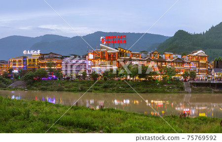 Wulingyuan, China - May 27, 2018: Town Wulingyuan at sunset in Tianzi Avatar mountains nature park Wulingyuan, China - May 27, 2018: Town Wulingyuan at sunset in Tianzi Avatar mountains nature park 75769592