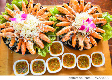 Seafood buffet Thai food, Grilled shrimp prawn with fresh vegetable and seafood sauce shrimps grilled serve on tray Seafood buffet Thai food, Grilled shrimp prawn with fresh vegetable and seafood sauce shrimps grilled serve on tray 75770009
