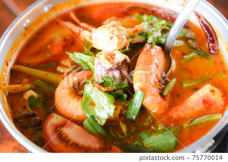 Prawn soup, Spicy soup with shrimp seafood coconut milk and chili pepper in pot, Hot and sour curry shrimps and squid Thai food Asian Prawn soup, Spicy soup with shrimp seafood coconut milk and chili pepper in pot, Hot and sour curry shrimps and squid Thai food Asian 75770014