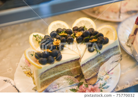 Cake on shelf with cake blueberry and lemon on store bakery shop Cake on shelf with cake blueberry and lemon on store bakery shop 75770032