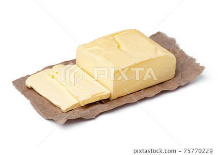 Fresh butter on craft paper isolated on white background Fresh butter on craft paper isolated on white background 75770229