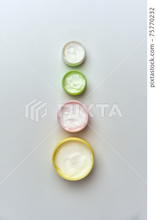 multi-colored jars with white cosmetic cream for face multi-colored jars with white cosmetic cream for face 75770232
