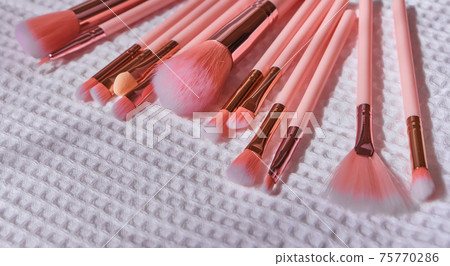 Wet make up brushes on towel, closeup 75770286