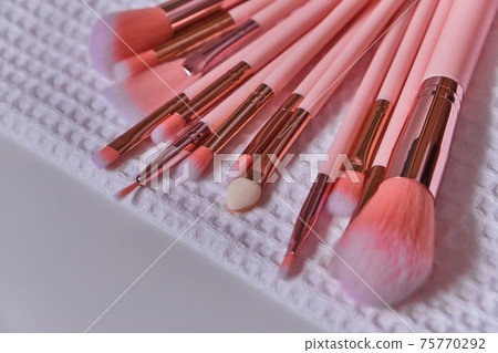 Wet make up brushes on towel, closeup 75770292