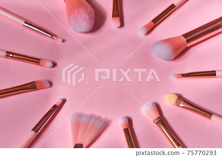 set of makeup brushes on a pink background 75770293