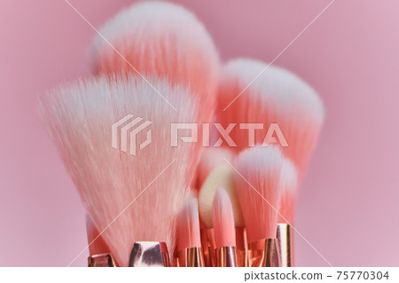 pink makeup brushes on a pink background 75770304