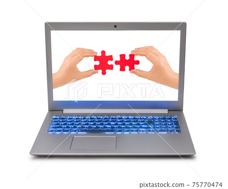 Hands and puzzle in computer notebook Hands and puzzle in computer notebook 75770474