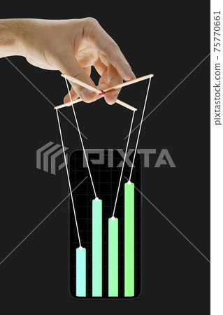 Businessman keeping the growth in economy, manipulating graphs like puppet 75770661