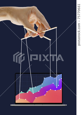 Businessman keeping the growth in economy, manipulating graphs like puppet 75770681