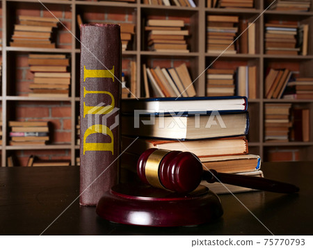 DUI law or driving under the influence book stands next to the gavel. 75770793