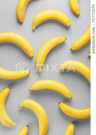 Geometric pattern of yellow bananas on a gray background in the Fashionable colors of 2021. Geometric pattern of yellow bananas on a gray background in the Fashionable colors of 2021. 75772070