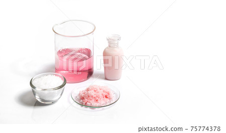 Pink flake chemicals, Potassium Permanganate Liquid and Cetyl esters wax on white laboratory table. 75774378