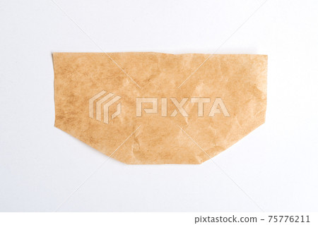 Close up of a ripped piece of brown paper on white background Close up of a ripped piece of brown paper on white background 75776211