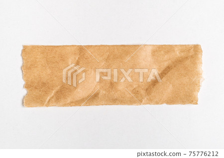 Close up of a ripped piece of brown paper on white background Close up of a ripped piece of brown paper on white background 75776212