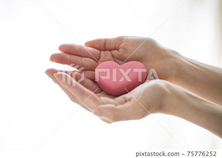 Affectionate woman's hand with a heart 75776252