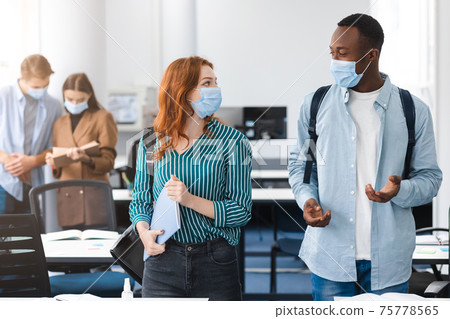 International students wearing medical masks and talking International students wearing medical masks and talking 75778565