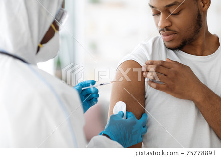 Doctor making flu vaccine for black guy 75778891