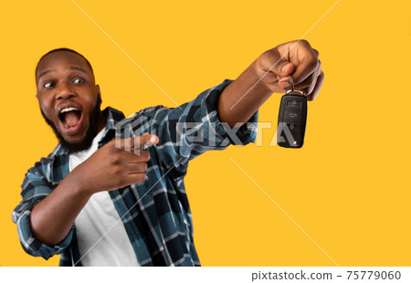 Black Man Showing New Car Key Posing On Yellow Background Black Man Showing New Car Key Posing On Yellow Background 75779060