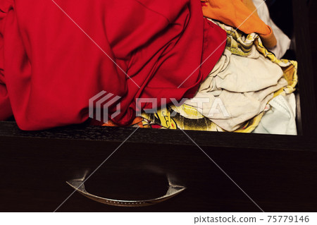 Open chest of drawers with linen. Open chest of drawers with linen. 75779146
