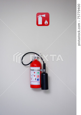 Fire extinguisher and fire department sign on a white wall. Fire extinguisher and fire department sign on a white wall. 75779400