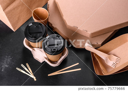 Disposable dishes made of environmentally friendly brown cardboard on a dark background 75779666