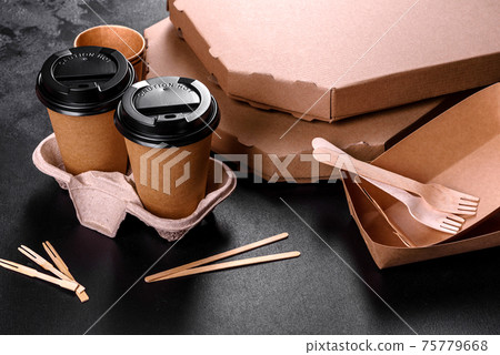 Disposable dishes made of environmentally friendly brown cardboard on a dark background 75779668