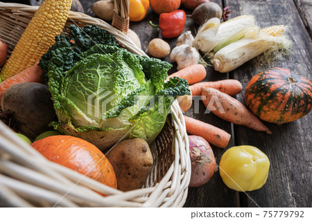 Wicker basket full of various vegetables 75779792