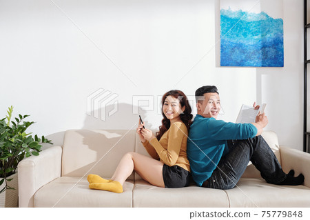 Couple resting on sofa Couple resting on sofa 75779848