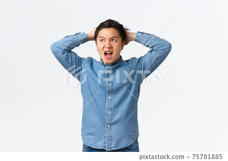 Troubled and concerned asian guy panicking, having big trouble, facing terrible situation, holding hands on head indecisive and frustrated, looking away, dont know what do, white background Troubled and concerned asian guy panicking, having big trouble, facing terrible situation, holding hands on head indecisive and frustrated, looking away, dont know what do, white background 75781885