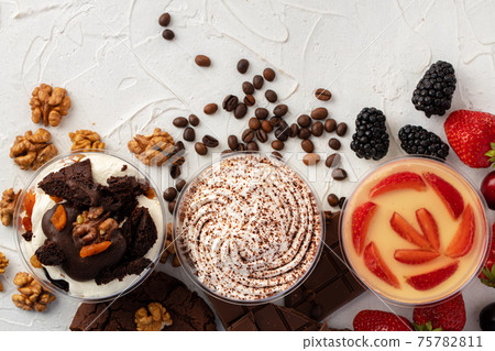 Cocoa mousse dessert in plastic transparent box on grey surface Cocoa mousse dessert in plastic transparent box on grey surface 75782811