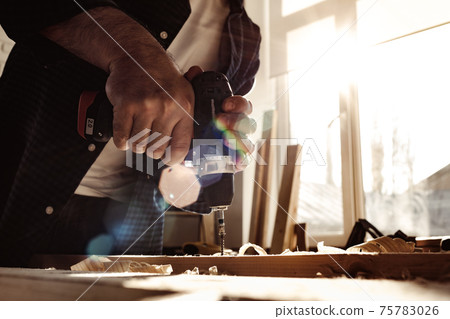 Close up of a carpenter drilling a hole in timber Close up of a carpenter drilling a hole in timber 75783026