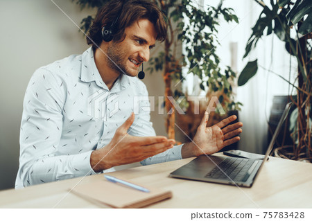 Young caucasian businessman holding video call with clients partners 75783428