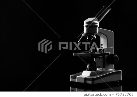 laboratory microscope on table in the dark laboratory microscope on table in the dark 75783705