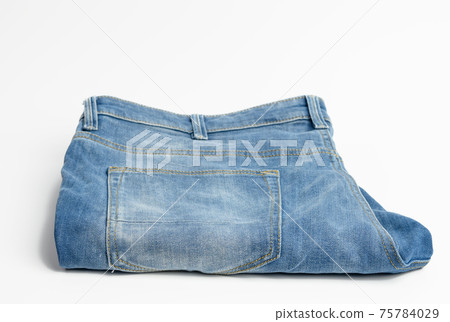 folded blue men's jeans on a white background 75784029