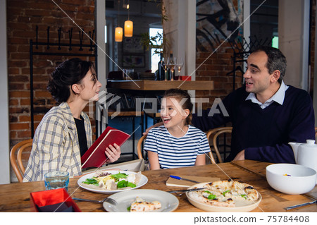 Happy mother received an albom from her family. 75784408