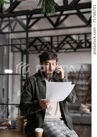 Modern Bearded Businessman Speaking by Smartphone 75786701