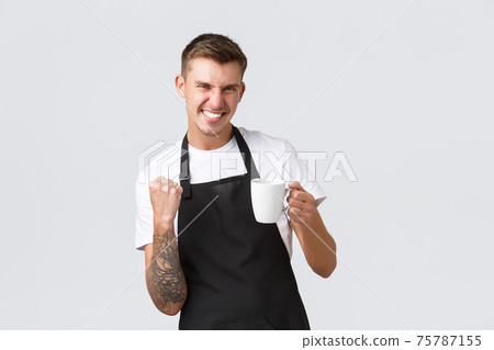 Small business, coffee shop, cafe and restaurants concept. Handsome enthusiastic barista inviting for cup of drink, holding mug and fist pump joyful, triumphing or saying yes, white background 75787155