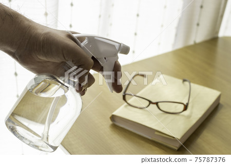 Image of alcohol disinfecting books and glasses 75787376