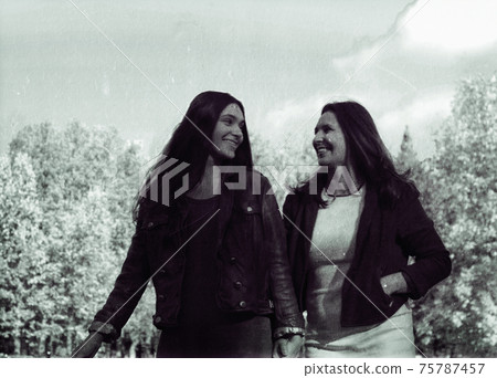 mature real mother with daughter outside autumn fall in park mature real mother with daughter outside autumn fall in park 75787457