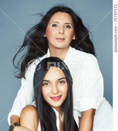 cute pretty teen daughter with mature mother hugging, fashion style brunette, lifestyle people concept cute pretty teen daughter with mature mother hugging, fashion style brunette, lifestyle people concept 75787572